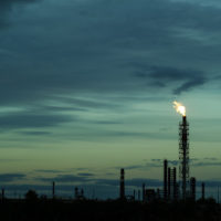 night silhouette industrial landscape - flares for flaring associated gas in an oil field