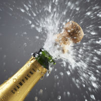 Champagne bottle popping cork, close-up