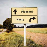 Street Sign the Direction Way to Pleasant versus Nasty