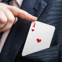 hand pulls the card ace of hearts close up