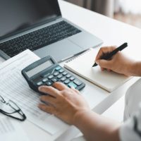 Woman-Is-Calculating-Annual-Ta-min