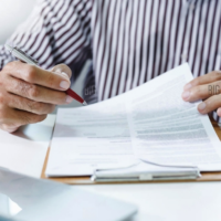 The deductibility of financial advice fees photo-businessman-reviewing-document-report-and-business-contract-before-sign-at-office-legal-expert