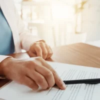 Queensland extends trust vesting date to 125 years pen-paperwork-hands-woman-signature