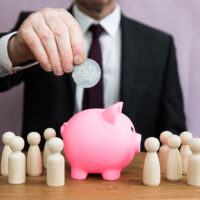 Payday Super and SMSFs A business concept of a businessman paying or contributing into an employee salary, pension, tax, bonus or incentive scheme